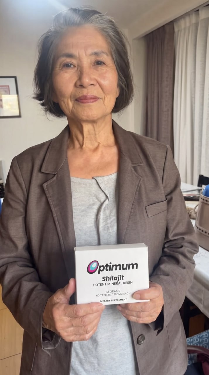 Joan F., verified Optimum customer holding the box